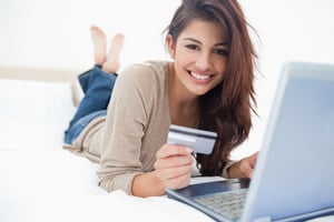 A woman smiling while looking at her credit history